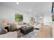 Bright and airy living room with comfortable seating and an open concept dining area at 974 N Faver Dr, Castle Rock, CO 80109