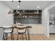 Stylish wet bar with modern lighting, open shelving, and sleek countertops at 974 N Faver Dr, Castle Rock, CO 80109