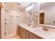Bright bathroom featuring a double vanity, a large mirror, and a glass-enclosed shower with white subway tile at 3346 N Josephine St, Denver, CO 80205