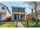 Charming gray two-story home with a black wrought iron fence and manicured front yard at 3346 N Josephine St, Denver, CO 80205