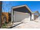 Detached garage with white door, offering secure parking and additional storage space at 3346 N Josephine St, Denver, CO 80205
