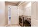 Convenient laundry room with modern washer and dryer, adjacent to another room, for efficient chore management at 3346 N Josephine St, Denver, CO 80205