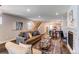 Open-concept living room showcasing hardwood floors, fireplace, and seamless flow to dining area at 3346 N Josephine St, Denver, CO 80205