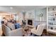 Comfortable living room with fireplace and an adjacent dining area with abundant light at 3346 N Josephine St, Denver, CO 80205