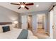 Bedroom with barn door and bathroom view features neutral paint and a ceiling fan at 3346 N Josephine St, Denver, CO 80205