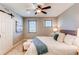 Bedroom featuring neutral paint, ceiling fan, and a sliding barn door for the bathroom at 3346 N Josephine St, Denver, CO 80205