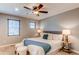 Bedroom featuring neutral paint, ceiling fan, and a sliding barn door for the bathroom at 3346 N Josephine St, Denver, CO 80205