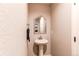 Small powder room with a pedestal sink, mirror, and neutral wall color at 3346 N Josephine St, Denver, CO 80205