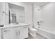 Clean bathroom featuring a modern vanity, toilet, and shower-tub combination with white tile surround at 17809 Fox St, Broomfield, CO 80023