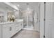 Bright bathroom features a double sink vanity, tiled shower, and modern fixtures at 17809 Fox St, Broomfield, CO 80023