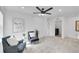 Comfortable carpeted bedroom features a ceiling fan, stylish seating, and modern artwork at 17809 Fox St, Broomfield, CO 80023