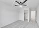 Bright bedroom featuring a ceiling fan, neutral carpet, and closet with custom shelving for optimal storage at 17809 Fox St, Broomfield, CO 80023