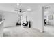 Bright bedroom featuring neutral carpeting, a ceiling fan, and a seating area at 17809 Fox St, Broomfield, CO 80023