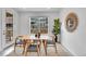 Cozy dining area with modern table set, jute rug, natural light, and plant at 17809 Fox St, Broomfield, CO 80023