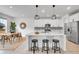 Open concept kitchen with stainless steel appliances, island with seating, and adjacent dining area at 17809 Fox St, Broomfield, CO 80023