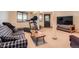 Finished basement with a cozy couch, treadmill, and entertainment center at 10450 Hondah Dr, Littleton, CO 80127