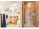 Well-lit bathroom with a tiled shower, vanity, and ample storage space at 10450 Hondah Dr, Littleton, CO 80127