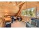 Cozy room with natural wood finishes, desk and a window with tree views at 10450 Hondah Dr, Littleton, CO 80127
