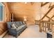 Comfortable room with wooden ceilings and railing and view of the downstairs at 10450 Hondah Dr, Littleton, CO 80127