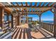 Beautiful wooden deck with a pergola, dining set, and stunning mountain views at 10450 Hondah Dr, Littleton, CO 80127