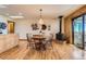 Dining area features a wood-burning stove, wood floors, and access to the patio at 10450 Hondah Dr, Littleton, CO 80127