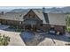 Charming log home with lush landscaping, covered porch, and mountain views at 10450 Hondah Dr, Littleton, CO 80127