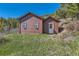 Charming home on a well-manicured lawn with window trim, a covered porch, and a bright white door at 10450 Hondah Dr, Littleton, CO 80127