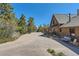 Inviting log home featuring a spacious driveway and charming front porch with a porch swing at 10450 Hondah Dr, Littleton, CO 80127