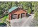 A two-car detached garage with green roof surrounded by lush trees at 10450 Hondah Dr, Littleton, CO 80127