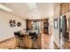Open kitchen features an island with seating and a view of the dining area at 10450 Hondah Dr, Littleton, CO 80127