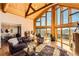 Spacious living room with vaulted ceilings and mountain views, wood floors at 10450 Hondah Dr, Littleton, CO 80127