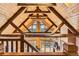 Unique architecture showcasing wooden beams, vaulted ceilings, and window views at 10450 Hondah Dr, Littleton, CO 80127