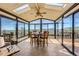 Bright sunroom with floor-to-ceiling windows offers stunning mountain views at 10450 Hondah Dr, Littleton, CO 80127