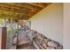 Underneath the house featuring brick pathway, exposed wood, and rock landscaping leading to stairs at 10450 Hondah Dr, Littleton, CO 80127