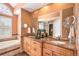 Bathroom features a double sink vanity, a soaking tub, and decorative mirrors at 9875 Greensview Cir, Lone Tree, CO 80124