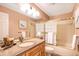 Bathroom with granite countertop vanity, bathtub-shower, and tiled walls at 9875 Greensview Cir, Lone Tree, CO 80124