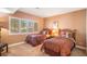 Comfortable bedroom featuring two beds, a window with shutters, and carpeted floors at 9875 Greensview Cir, Lone Tree, CO 80124