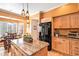 Eat-in kitchen with granite countertops, stainless appliances, and hardwood floors at 9875 Greensview Cir, Lone Tree, CO 80124