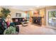 Inviting living room with a cozy fireplace and plush leather seating at 9875 Greensview Cir, Lone Tree, CO 80124