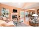 Bright living room featuring a fireplace, hardwood floors, comfortable seating, and large windows at 9875 Greensview Cir, Lone Tree, CO 80124