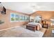 Spacious bedroom features a ceiling fan, multiple windows, and comfortable furnishings at 9875 Greensview Cir, Lone Tree, CO 80124
