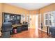 Well-appointed home office with built-in shelves, desk, wood floors, and French doors leading to the hallway at 9875 Greensview Cir, Lone Tree, CO 80124