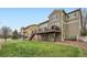 Grassy backyard with multilevel deck extending the living space outdoors and a full walkout basement at 527 Stonemont Dr, Castle Pines, CO 80108