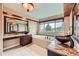 Bathroom with a soaking tub, beautiful cabinets, and a large window at 527 Stonemont Dr, Castle Pines, CO 80108