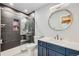Updated bathroom with stylish vanity, modern fixtures, frameless shower door, and eye-catching tile work at 527 Stonemont Dr, Castle Pines, CO 80108