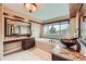 Bathroom features a soaking tub, granite counters, bronze vessel sinks, and a large window for natural light at 527 Stonemont Dr, Castle Pines, CO 80108