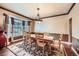 Formal dining room with hardwood floors, chandelier lighting, and natural light from bay window at 527 Stonemont Dr, Castle Pines, CO 80108