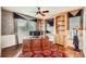 Well-lit home office featuring built-in bookshelves, a large desk, and stylish window treatments, ideal for productivity at 527 Stonemont Dr, Castle Pines, CO 80108