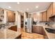 Modern kitchen featuring stainless steel appliances, granite countertops, and hardwood floors at 527 Stonemont Dr, Castle Pines, CO 80108