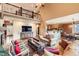 Open-concept living room showcasing the staircase and kitchen, with hardwood floors and comfortable seating at 527 Stonemont Dr, Castle Pines, CO 80108
